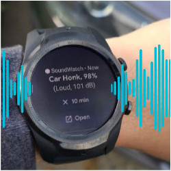 A user is standing in front of a car wearing a smartwatch that shows the recognized sound as car honk with a confidence level of 98%. Blue waveforms around the watch signify the watch vibrating.