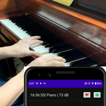 A person is playing an antique piano. An overlaid android mobile app shows the recognized sound: Piano